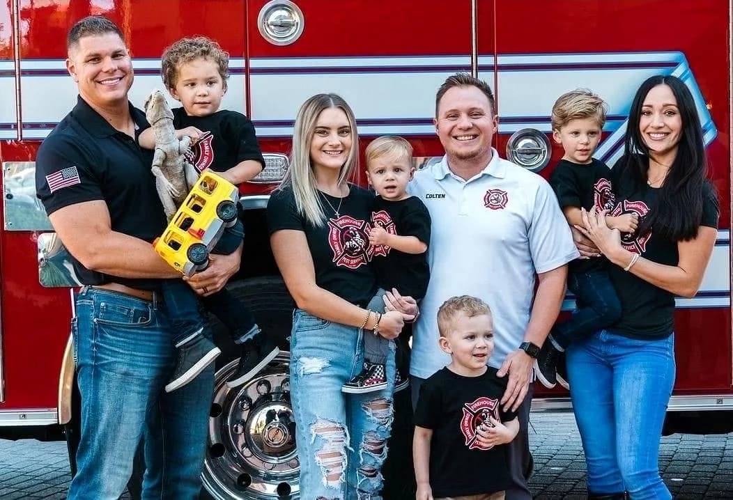 Firehouse Pest Control Services founders and families in front of a fire truck